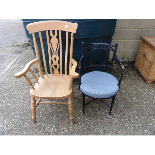 255 - A pine farmhouse carver chair together with an ebonised chair