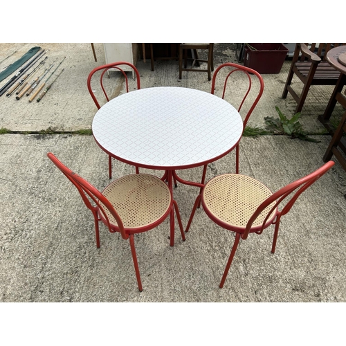 318 - A red circular bistro table with four chairs