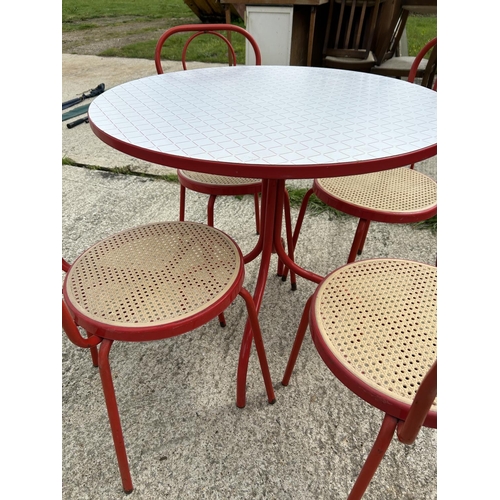 318 - A red circular bistro table with four chairs