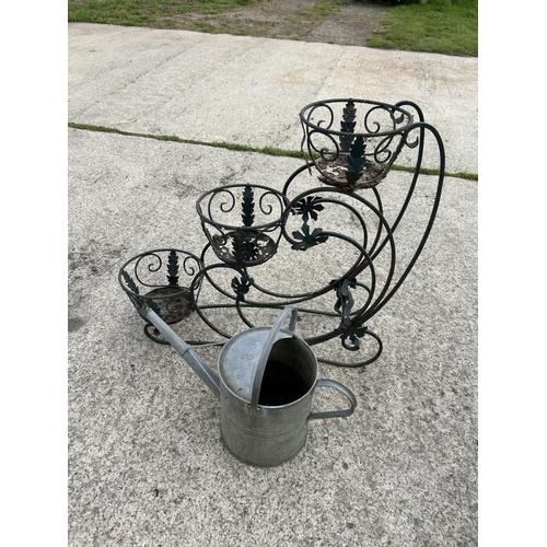 327 - A metal plant stand and a galvanised water can