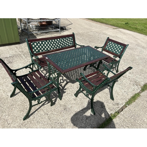 334 - A green painted iron framed garden table together with bench and three chairs