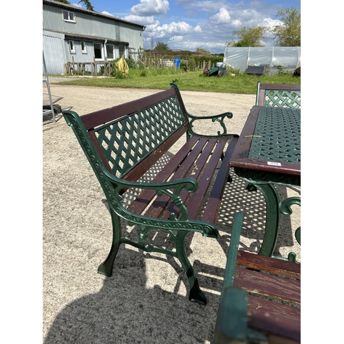 334 - A green painted iron framed garden table together with bench and three chairs