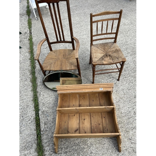 336 - A country pine wall shelf together with frameless mirror and two rush seat chairs