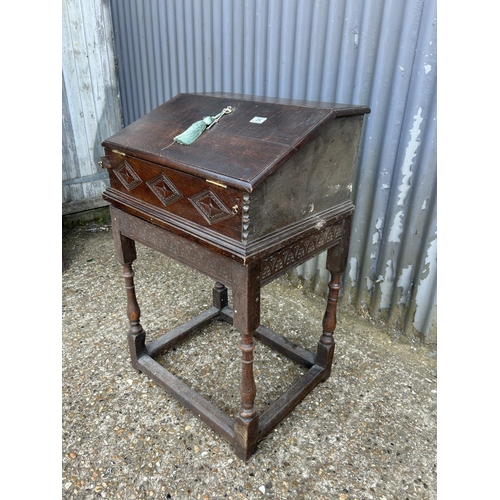 34 - An antique carved oak bureau desk with fitted interior and well 60x50x100