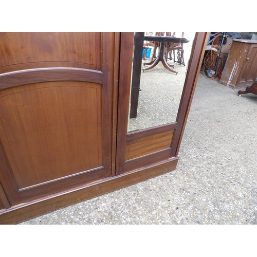 343 - A large Edwardian mahogany triple wardrobe with inlay and fitted interior