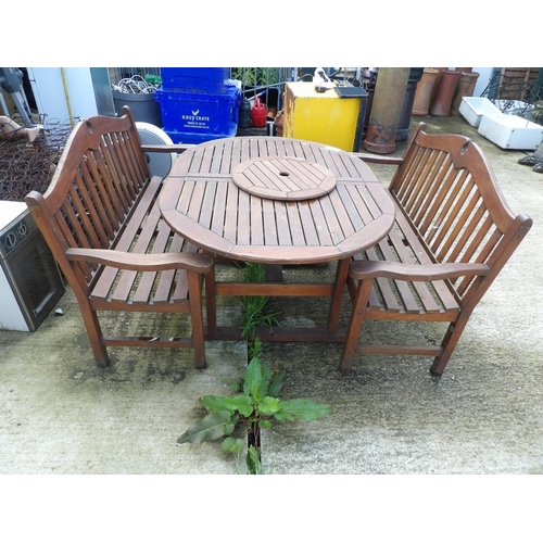 371 - An extending wooden garden table with two benches and lazy Susan