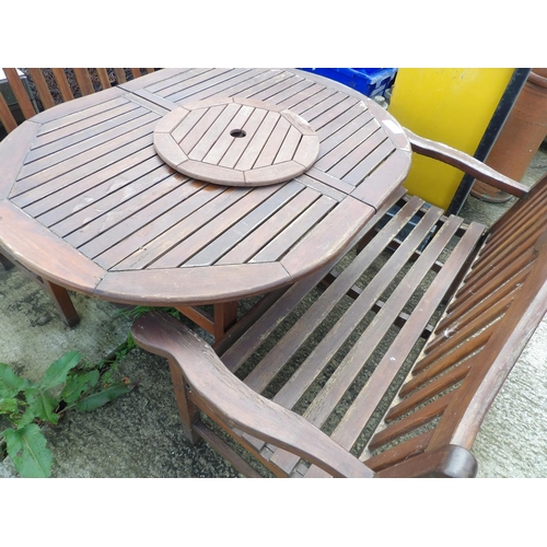 371 - An extending wooden garden table with two benches and lazy Susan