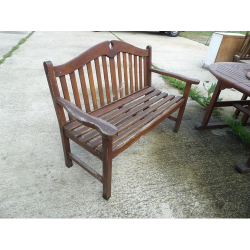 371 - An extending wooden garden table with two benches and lazy Susan