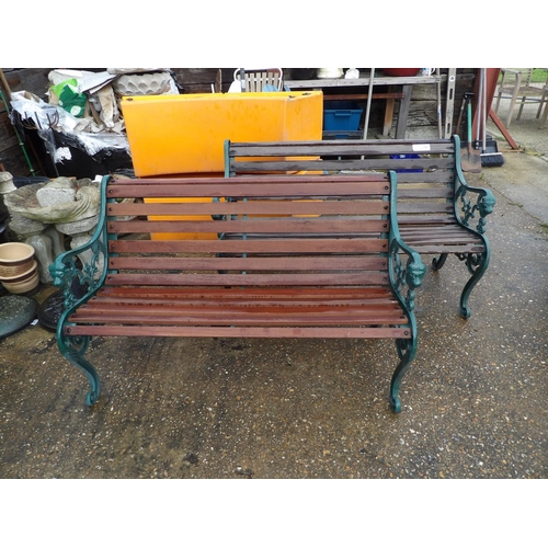 407 - A pair of ornate iron framed garden bench seats with hardwood slatted seats