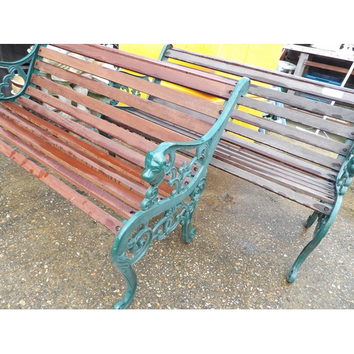 407 - A pair of ornate iron framed garden bench seats with hardwood slatted seats