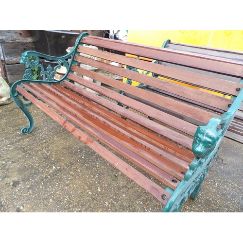 407 - A pair of ornate iron framed garden bench seats with hardwood slatted seats