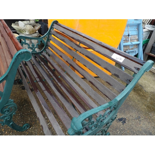 407 - A pair of ornate iron framed garden bench seats with hardwood slatted seats