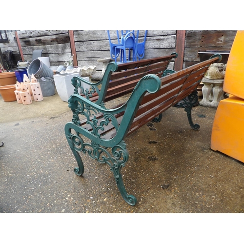 407 - A pair of ornate iron framed garden bench seats with hardwood slatted seats