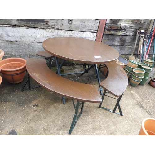 410c - A circular folding garden table together with three matching folding curved bench seats