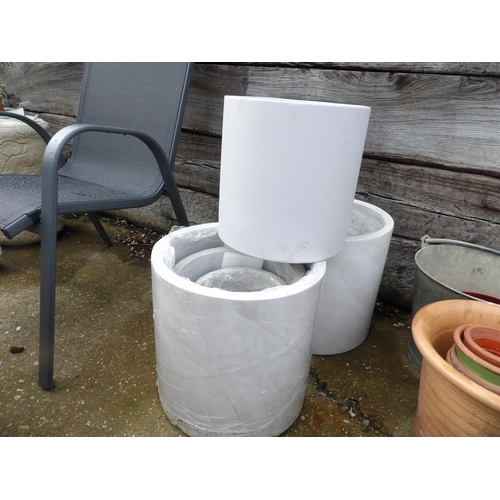 410o - A gradated set of three modern white cylinder planters together with two other similar cylinder plan... 