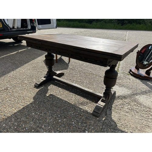 43 - A carved oak drawer leaf table 81x138