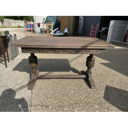 43 - A carved oak drawer leaf table 81x138