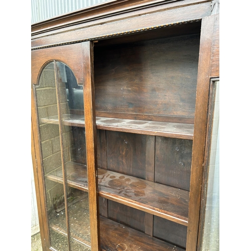 48 - A early 20th century glazed oak bookcase 92x27x125