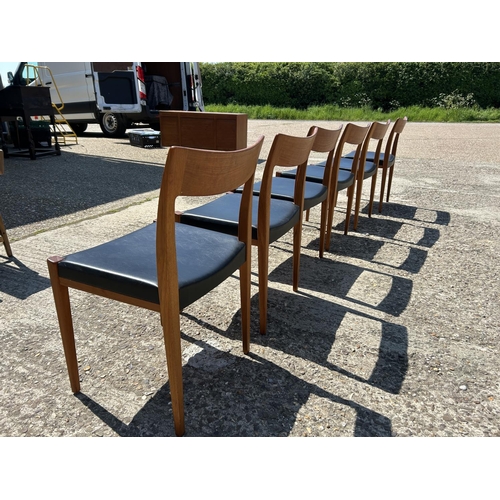 5 - A set of six danish teak dining chairs marked TROEDS MADE IN DENMARK with black vinyl seats (on chai... 