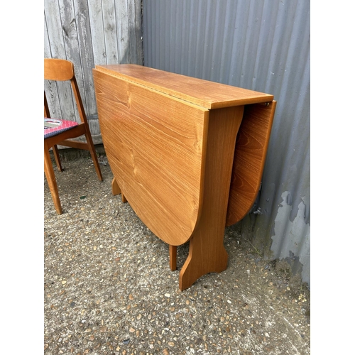 51 - A teak gateleg table and two chairs