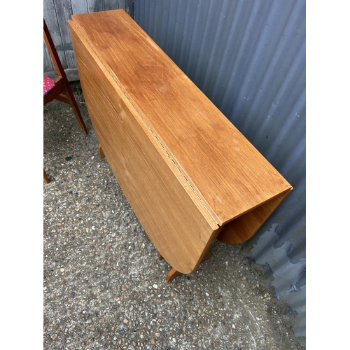 51 - A teak gateleg table and two chairs