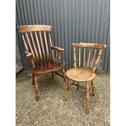 53 - A farmhouse carver chair together with a stick back kitchen chair