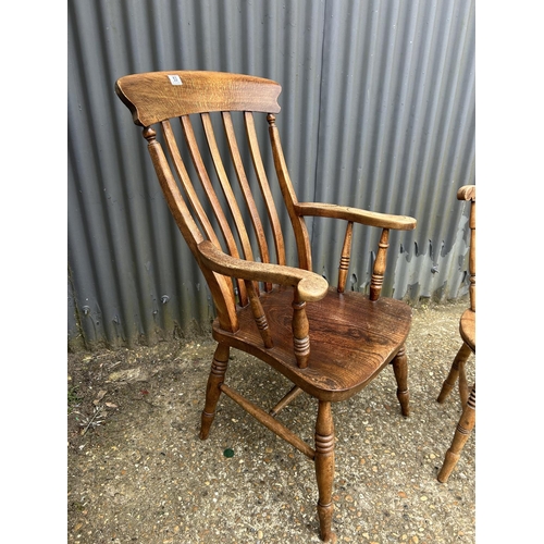 53 - A farmhouse carver chair together with a stick back kitchen chair