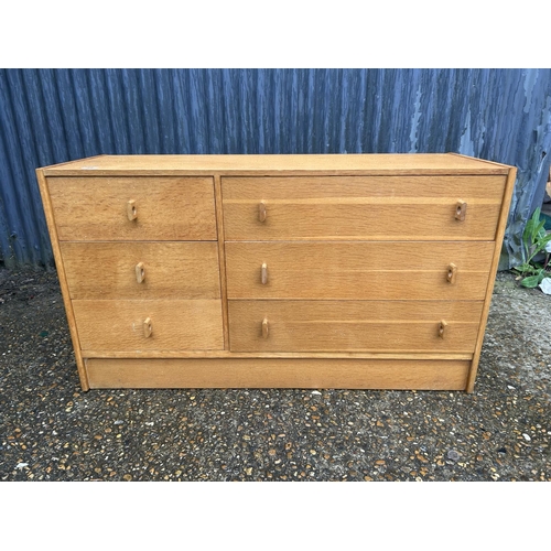 66 - A mid century light oak chest of six drawers