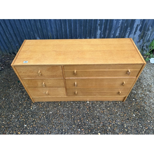 66 - A mid century light oak chest of six drawers