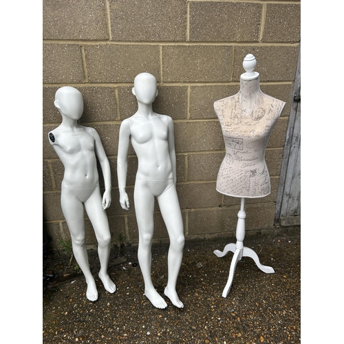 67 - A dress makers dummy together with two children size mannequins