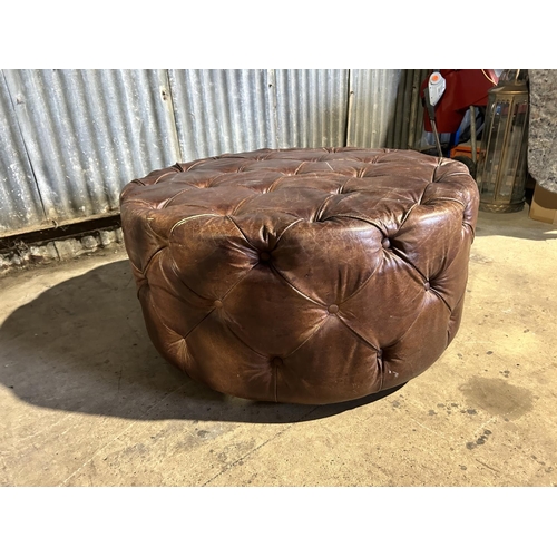 72 - A circular tan brown leather revolving chesterfield stool 100cm diameter