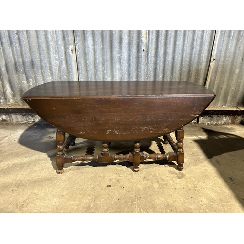 74 - An ercol dark elm drop leaf coffee table