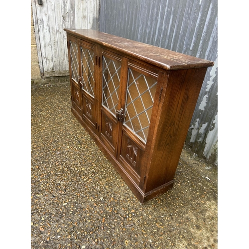 79 - A leaded oak bookcase 140x30x87