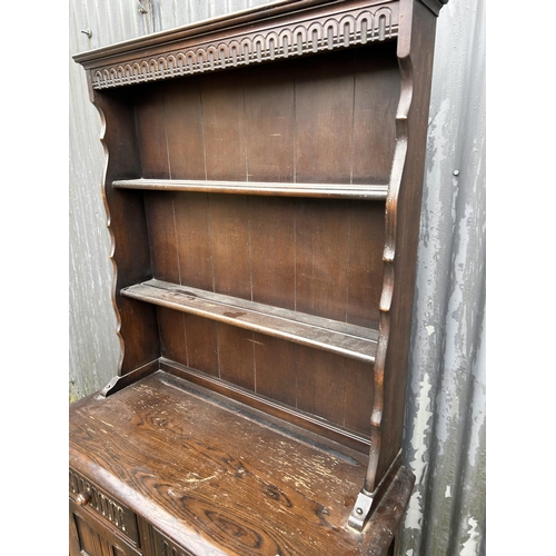 82 - A dark ercol,cottage dresser 95 cm wide