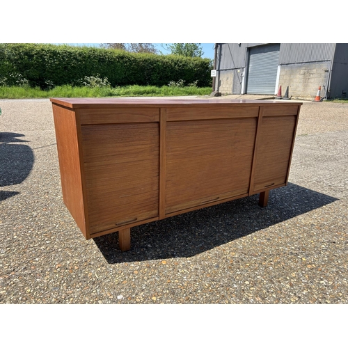 9 - A mid century teak triple tambour sideboard  137x45x70