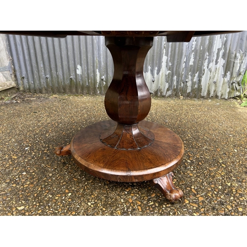 90 - A Victorian rosewood circular tilt top breakfast table 130 cm diameter