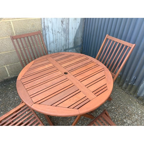 361A - A hardwood folding garden table and four chairs