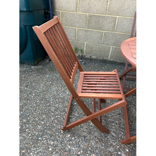 361A - A hardwood folding garden table and four chairs