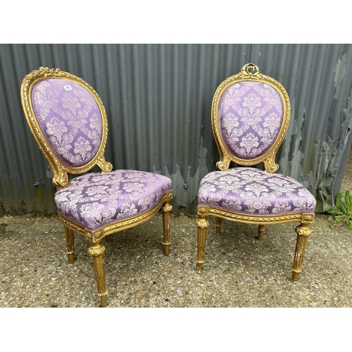 48 - A pair of gold gilt chairs with pink upholstery