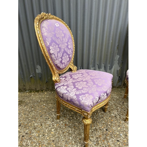 48 - A pair of gold gilt chairs with pink upholstery
