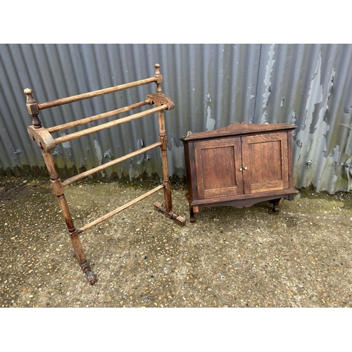 51 - An oak wall cabinet together with an Edwardian towel rail