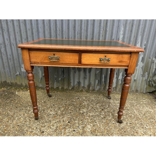 1 - An Edwardian mahogany two drawer writing table with green leather top 90x55x77