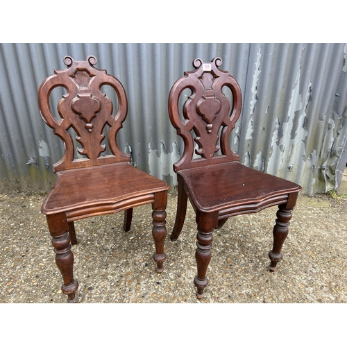 101 - A pair of Victorian mahogany hall chairs