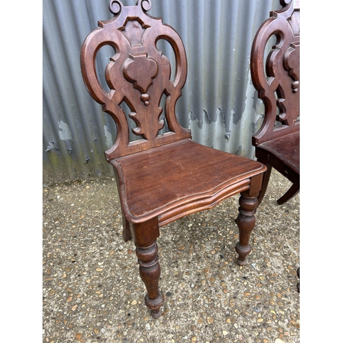 101 - A pair of Victorian mahogany hall chairs