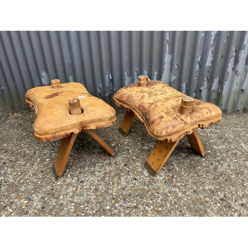 103 - A pair of leather top camel stools