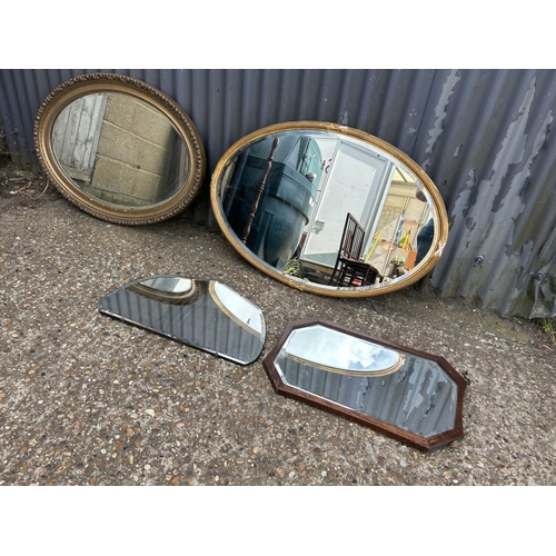 105 - Two large oval gold gilt mirrors together with two smaller wall mirrors
