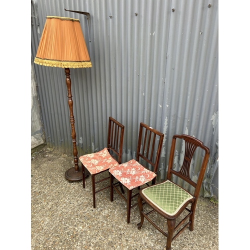 106 - Three mahogany chairs and a standard lamp with shade