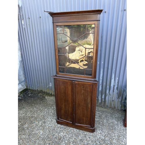 11 - A two section mahogany corner cabinet with glazed top over cupboard base