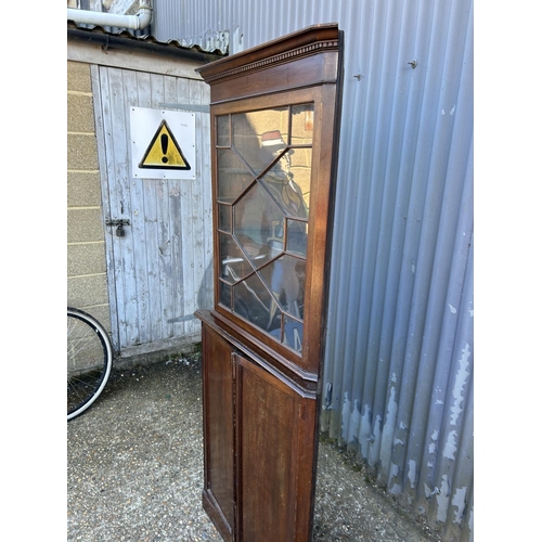 11 - A two section mahogany corner cabinet with glazed top over cupboard base