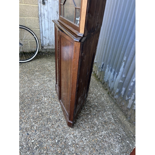 11 - A two section mahogany corner cabinet with glazed top over cupboard base